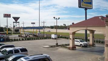 A parking lot with several cars, a sign for "Scottish Inns & Suites," and a "Golden Triangle" sign.