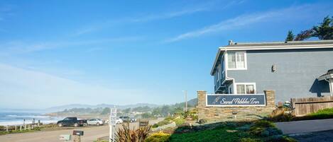 A hotel named 'Sand Pebbles Inn' with a view of the ocean.