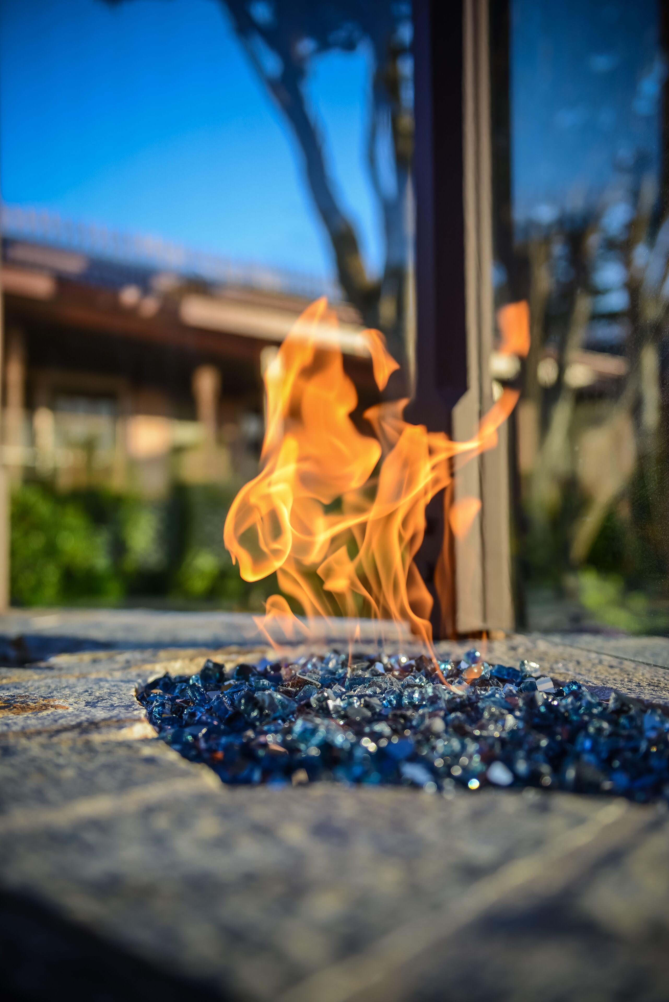 Ein Feuer brennt auf einem Haufen blauer Glasscherben.