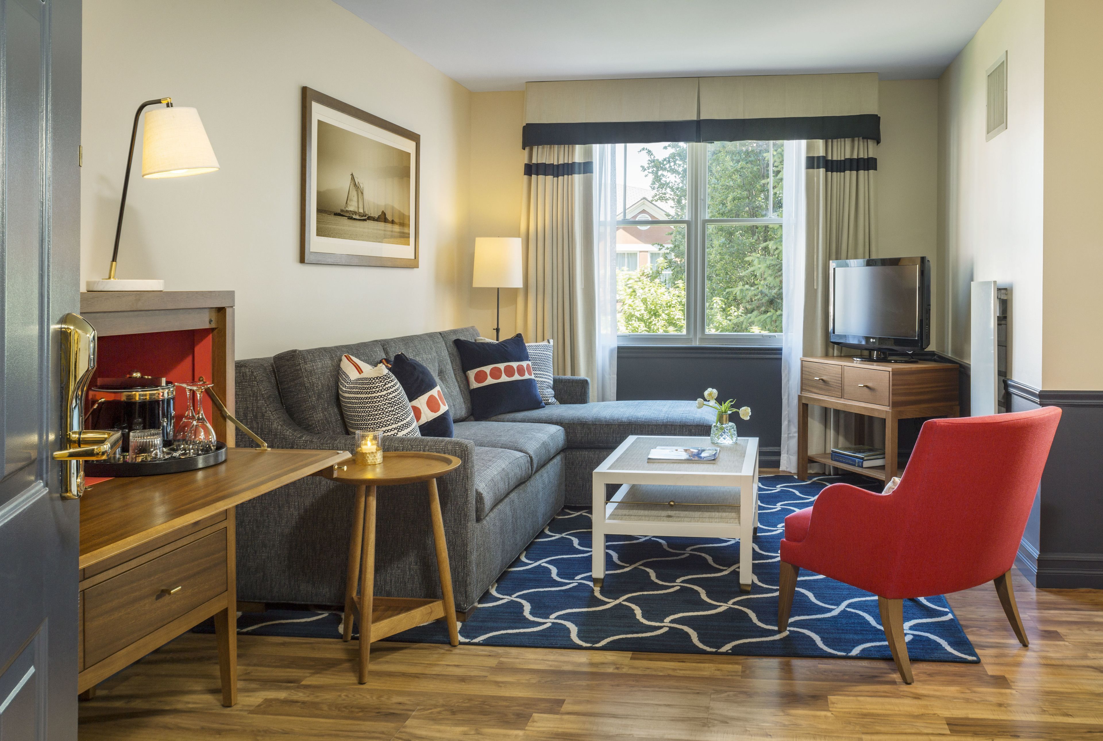 junior suite, 1 king bed with sofa bed | living area | 50-inch flat-screen tv with cable channels, tv, books