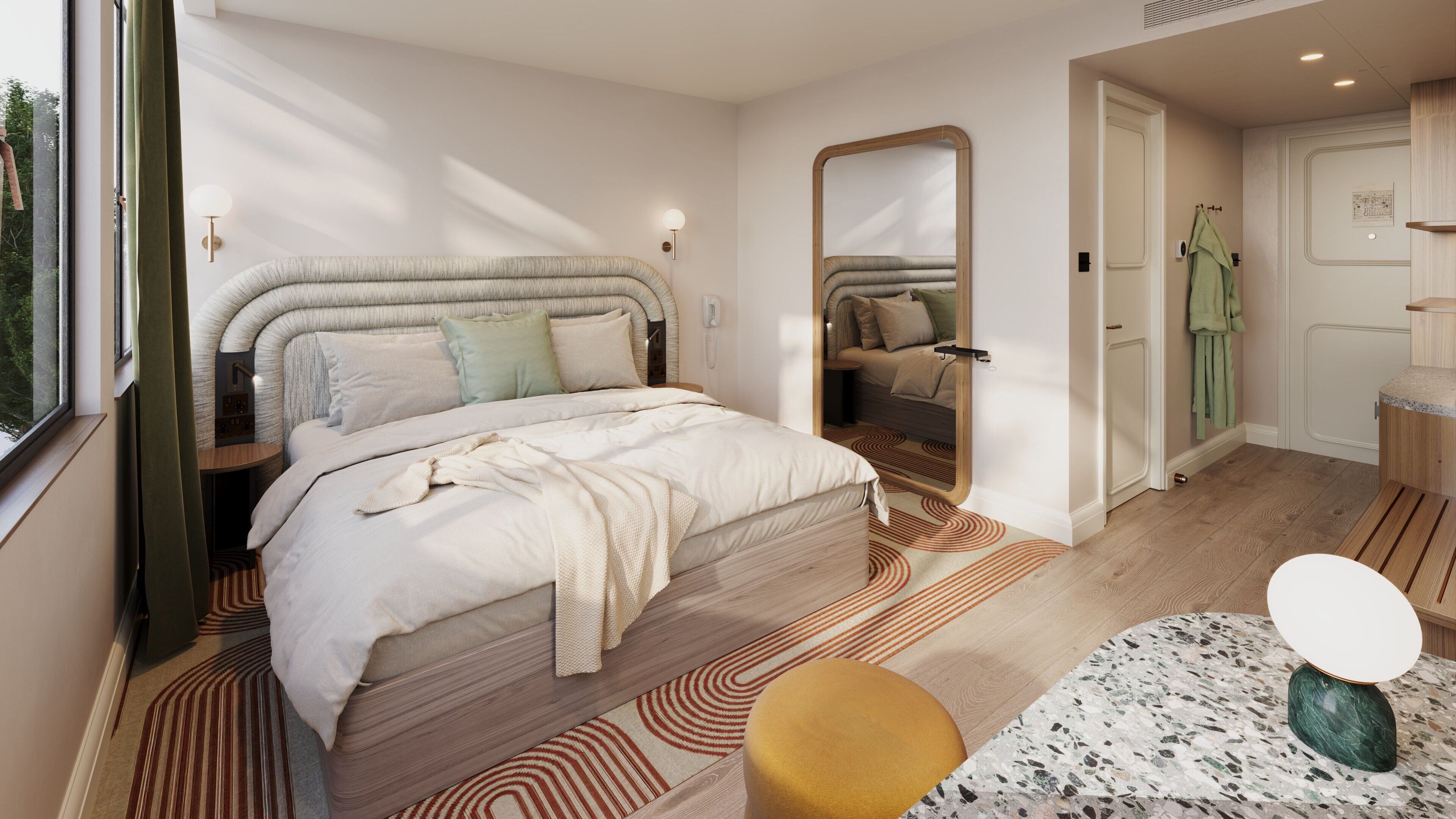 A modern bedroom with a large bed, a mirror, a bedside table, a round stool, and a small table with a decorative item.