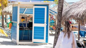 A beachside kiosk with a sign reading "TRYP BY WYNDHAM."