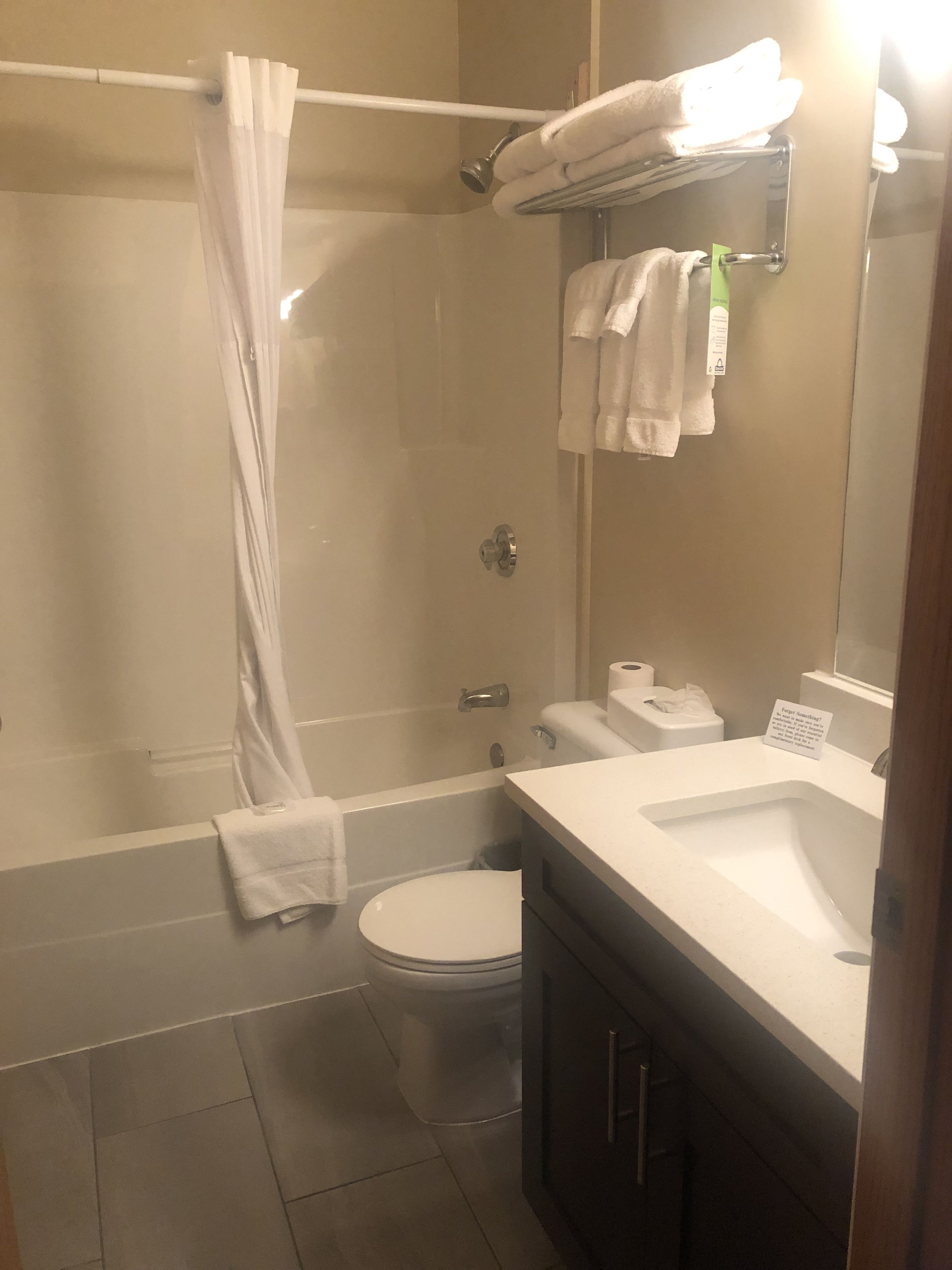 A bathroom with a bathtub, toilet, and sink.