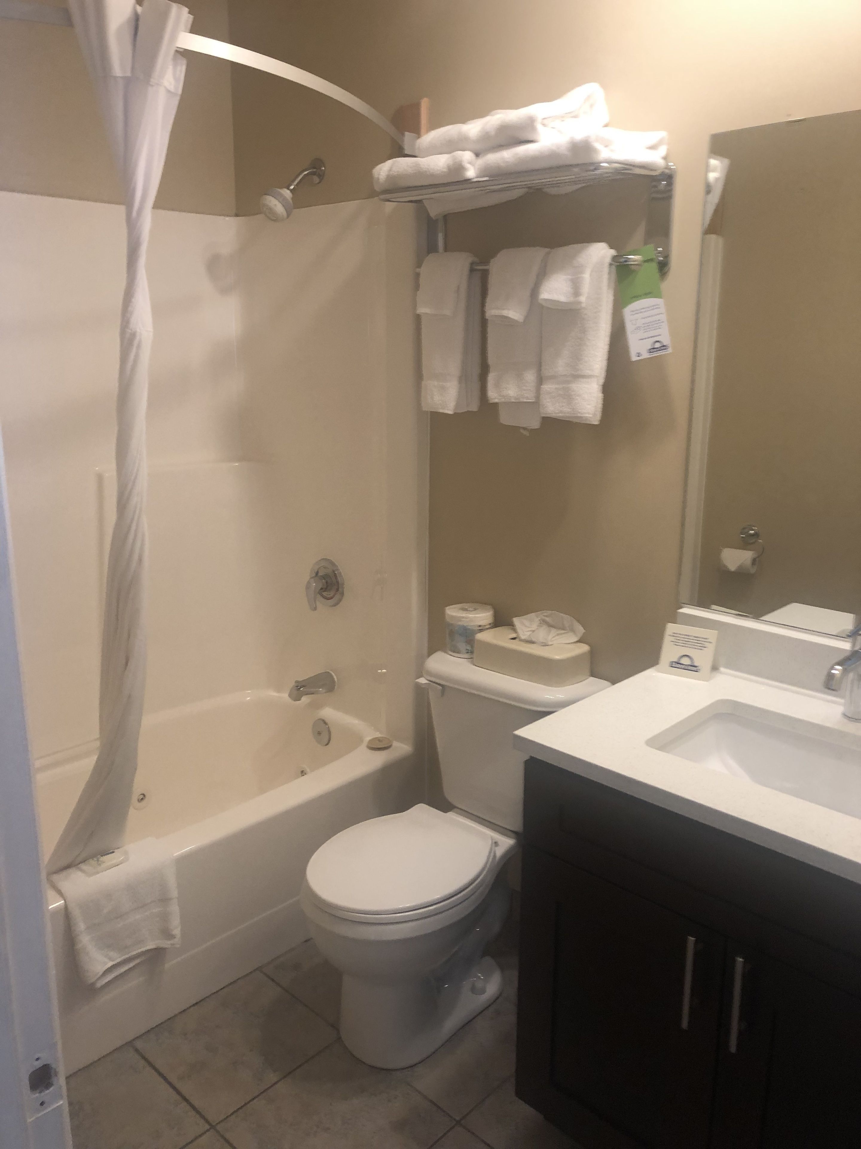 A bathroom with a bathtub, toilet, and sink.