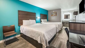 A hotel room with two beds, a desk, a chair, and a bathroom visible in the background. - Econo Lodge Russellville (Russellville)
