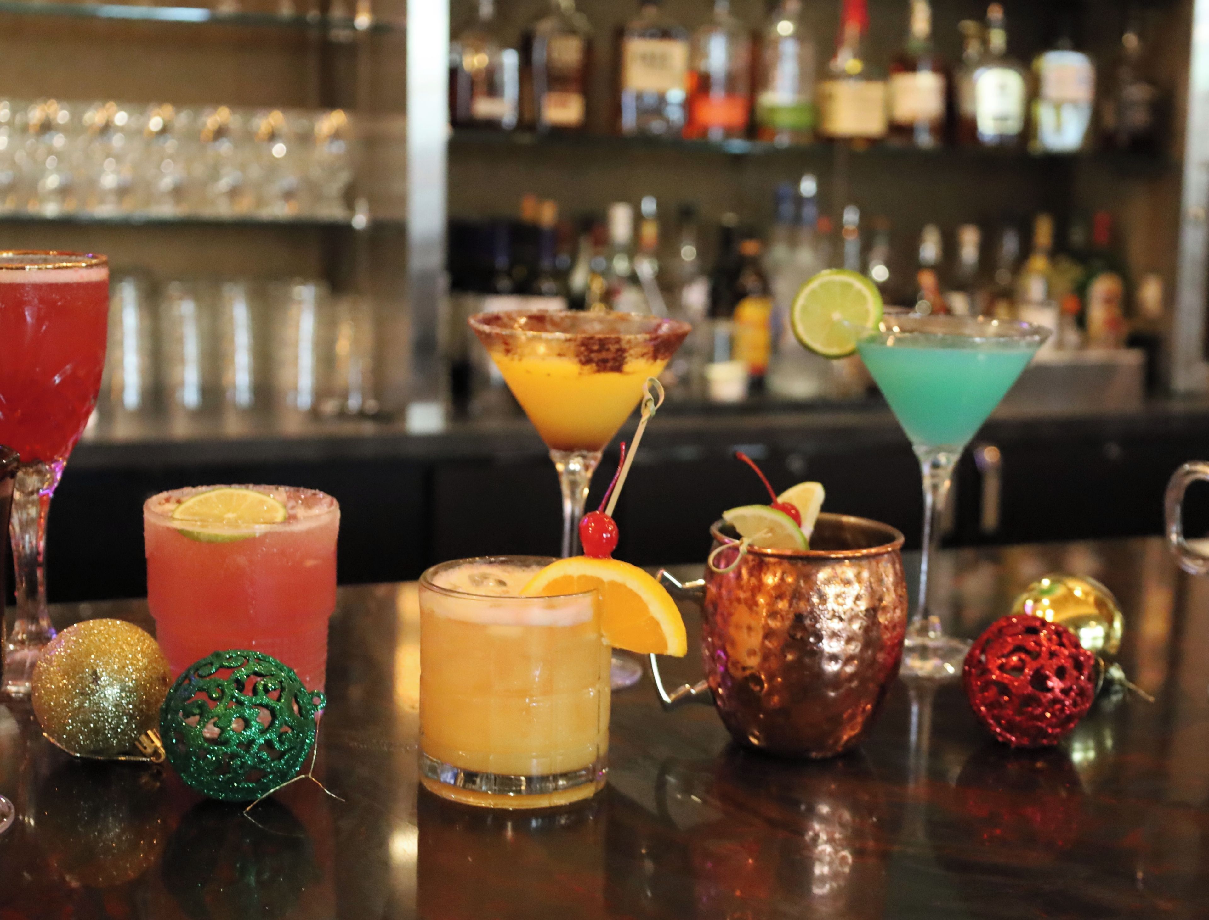 A bar with various drinks and decorative items.