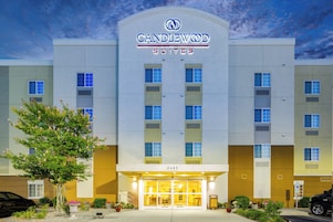 A hotel with a modern facade, a clear sky, and a well-maintained entrance area.