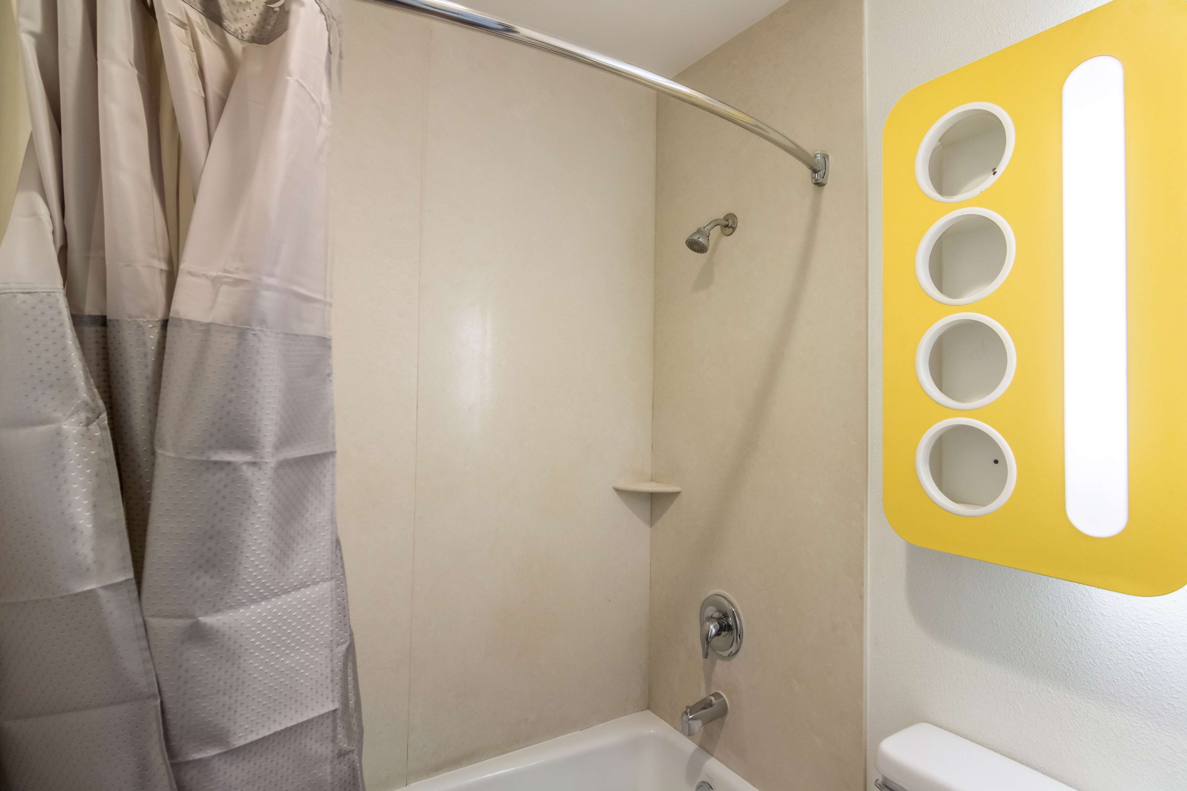 A bathroom with a shower, a bathtub, and a toilet.