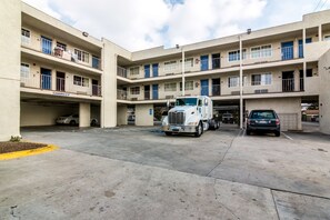 A multi-story parking garage with a white truck parked in the center. - Motel 6 Bell Gardens, CA - Los Angeles (Bell Gardens)