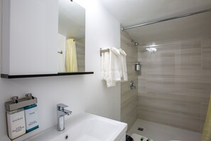 Family Room, 3 Queen Beds, Non Smoking, Refrigerator & Microwave | Bathroom | Shower, free toiletries, hair dryer, towels