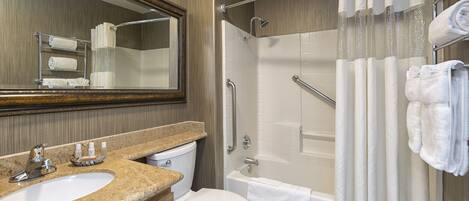 A bathroom with a sink, toilet, bathtub, and shower.