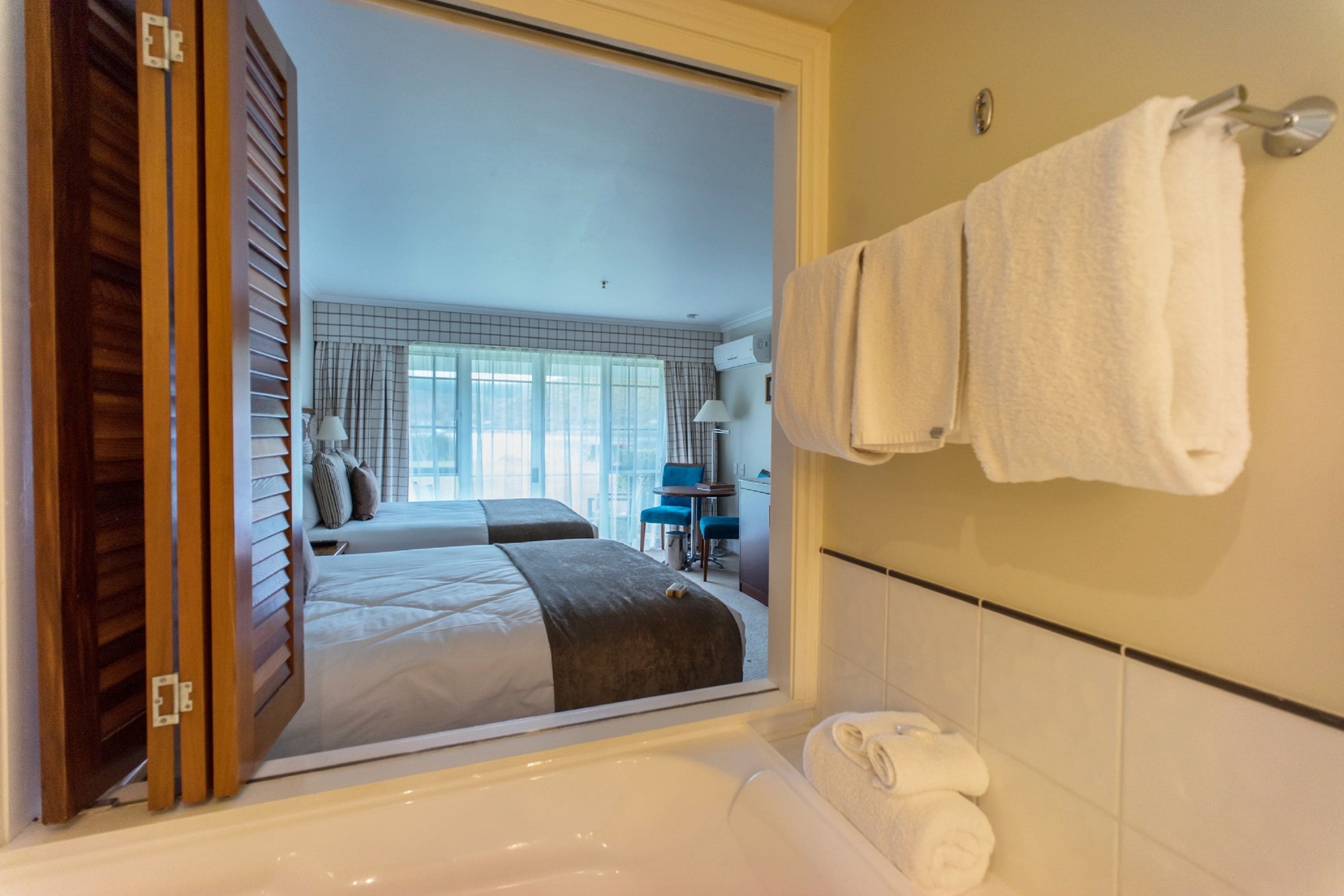 twin room, garden view | in-room safe, desk, laptop workspace, blackout curtains