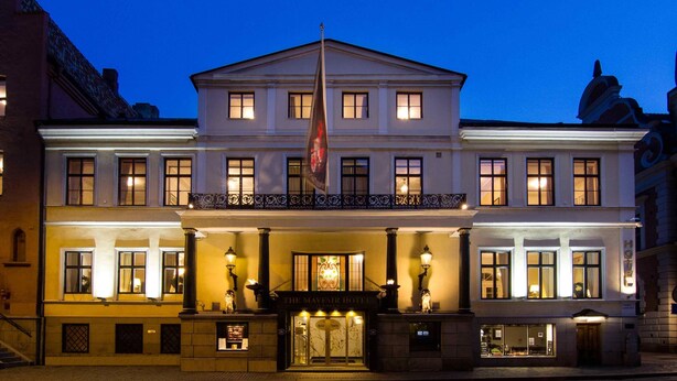 A historic hotel with a symmetrical facade, large windows, and a central entrance. - Mayfair Hotel Tunneln (Malmö)