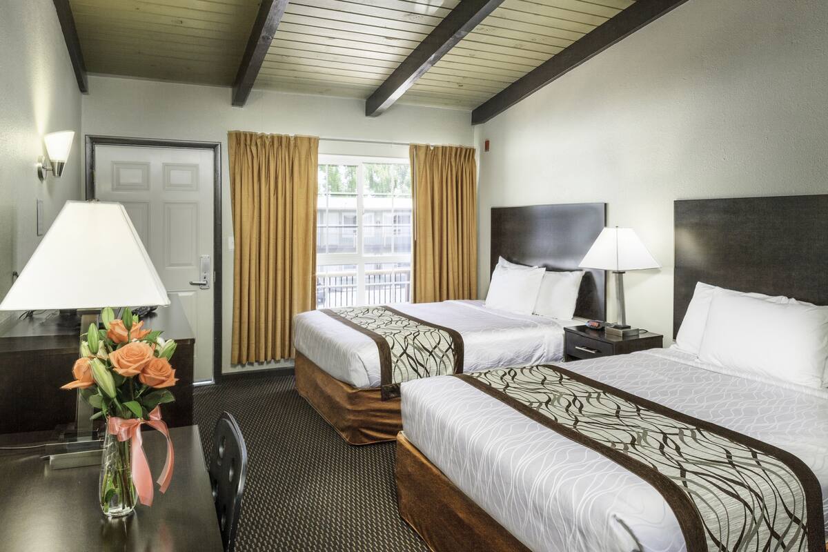 economy double room, 2 queen beds, non smoking | desk, laptop workspace, blackout curtains, iron/ironing board