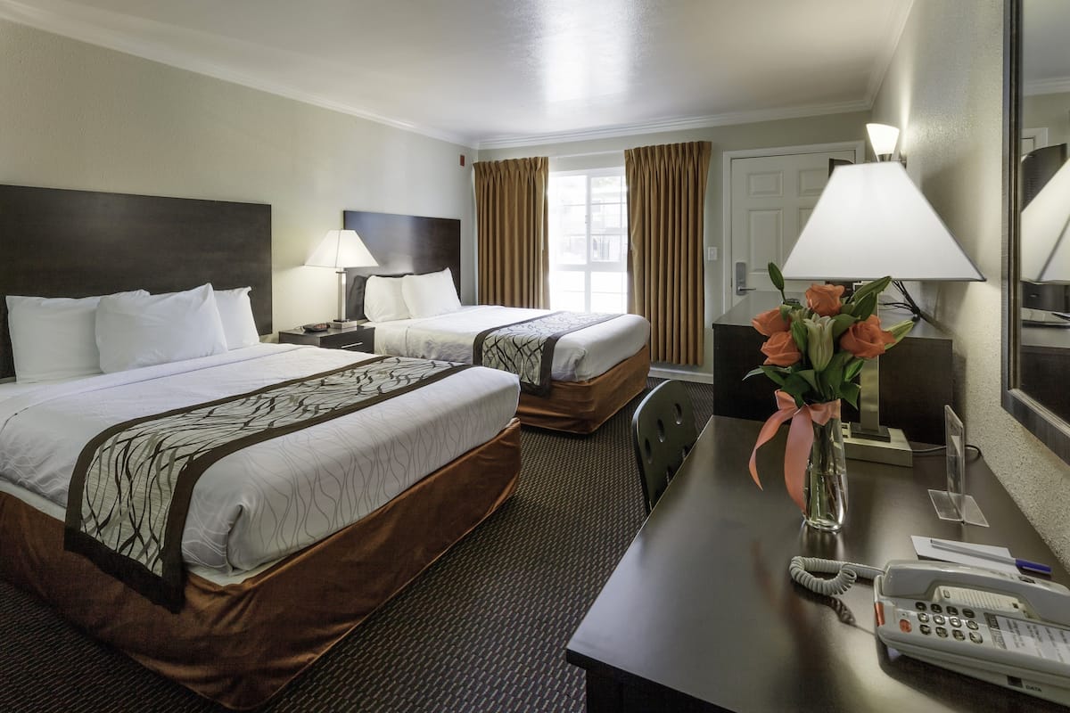 economy double room, 2 queen beds, non smoking | desk, laptop workspace, blackout curtains, iron/ironing board