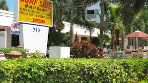 A SURF SIDE Motel Resort sign with a vacancy indicator, a AAA Approved Lodging badge, and the number 710.