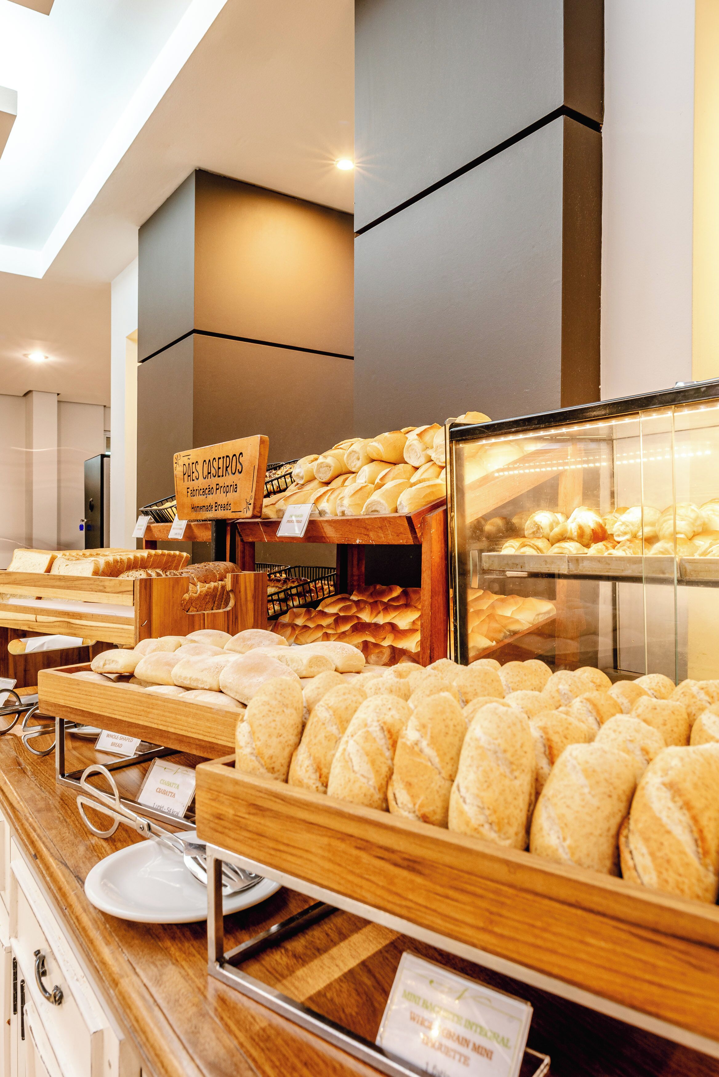 A bakery display with various types of bread and pastries.