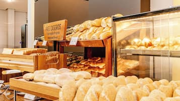 A bakery display with various types of bread and pastries.