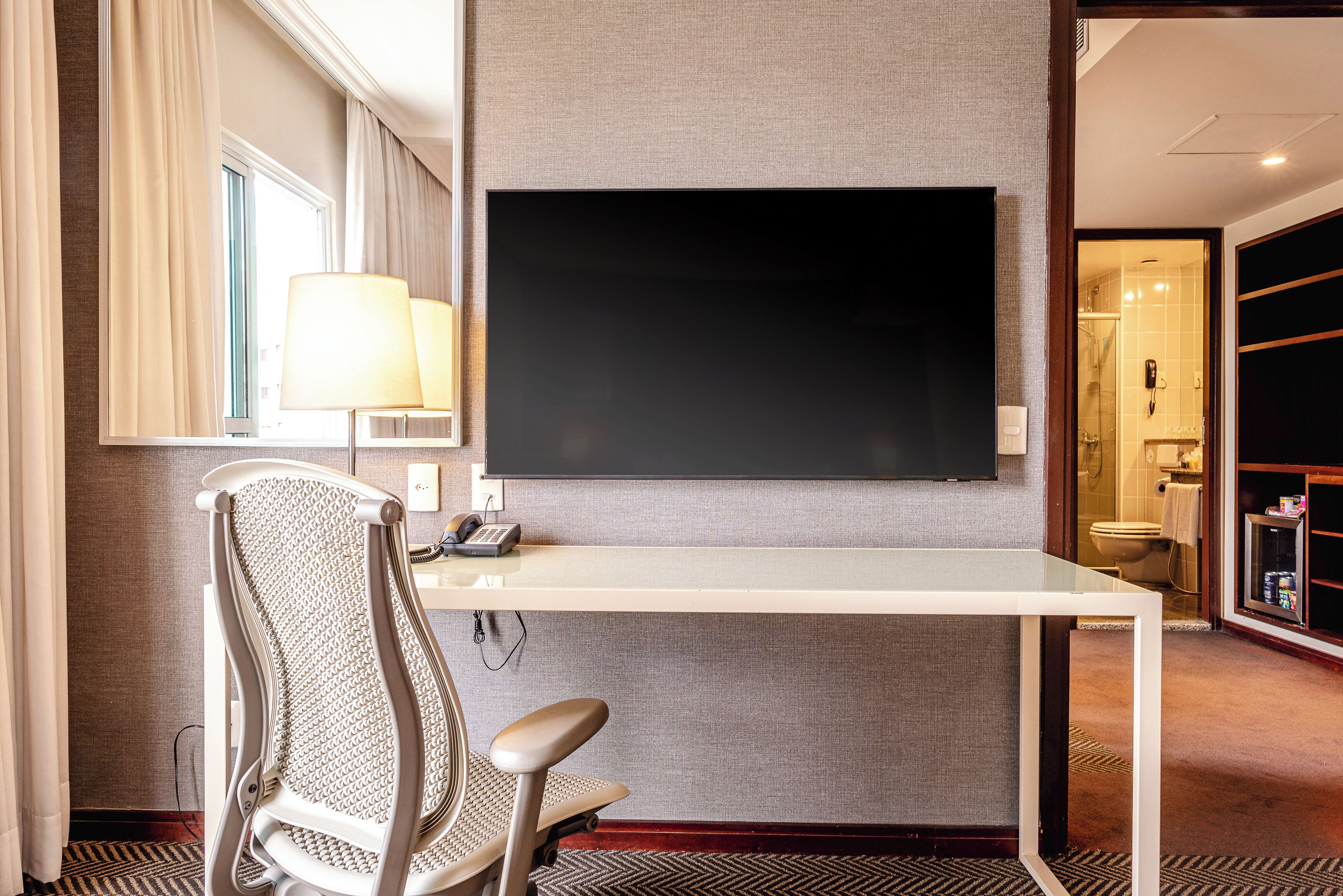 family room | minibar, in-room safe, desk, blackout curtains