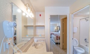 Deluxe Room, 2 Queen Beds | Bathroom | Hair dryer, towels