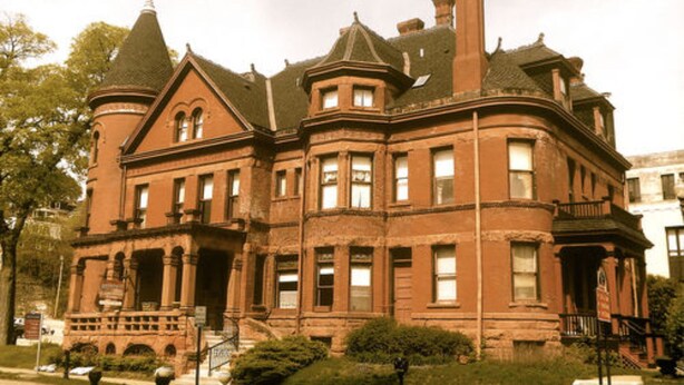 A large, historic brick building with multiple towers and a prominent entrance. - Redstone Inn And Suites (Dubuque)