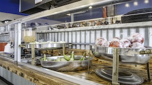 A buffet setup with various food items and condiments.