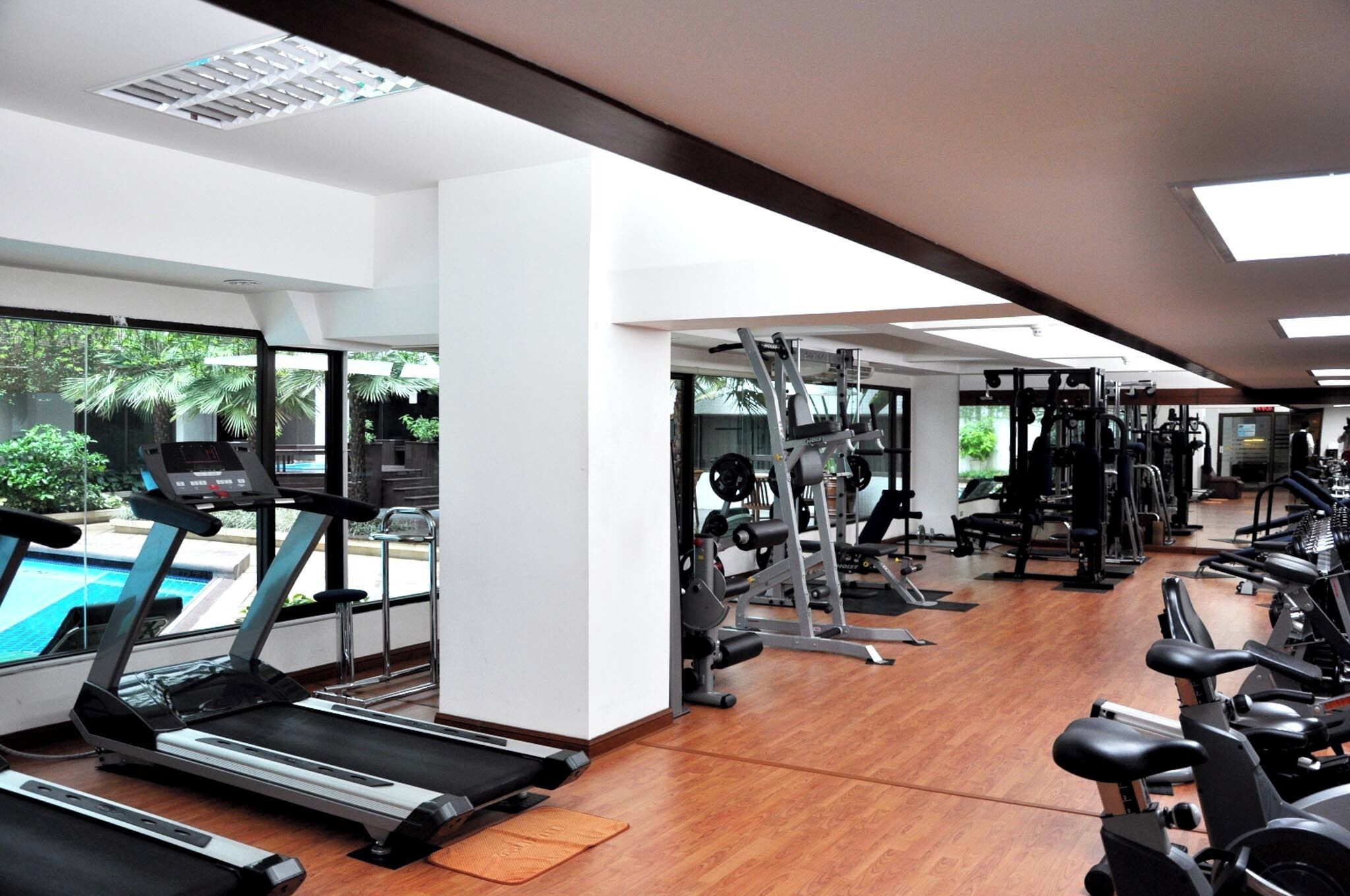 A gym with treadmills, stationary bikes, and weight machines.