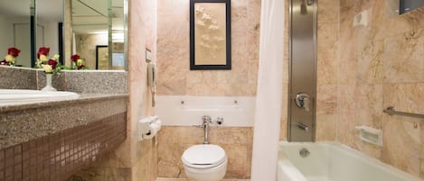 A bathroom with a toilet, sink, and bathtub.