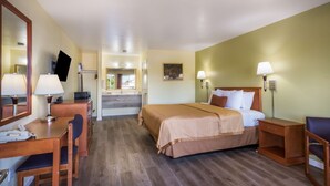 A hotel room with a bed, desk, chair, and a mirror. - Americas Best Value Inn Santa Rosa, CA (Santa Rosa)