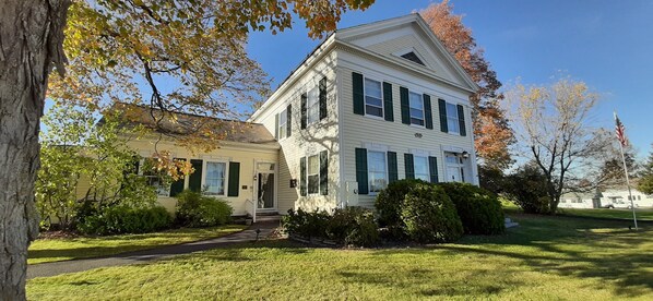 A two-story house with a front porch and a lawn.