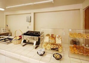 A buffet area with various food items displayed in clear containers.