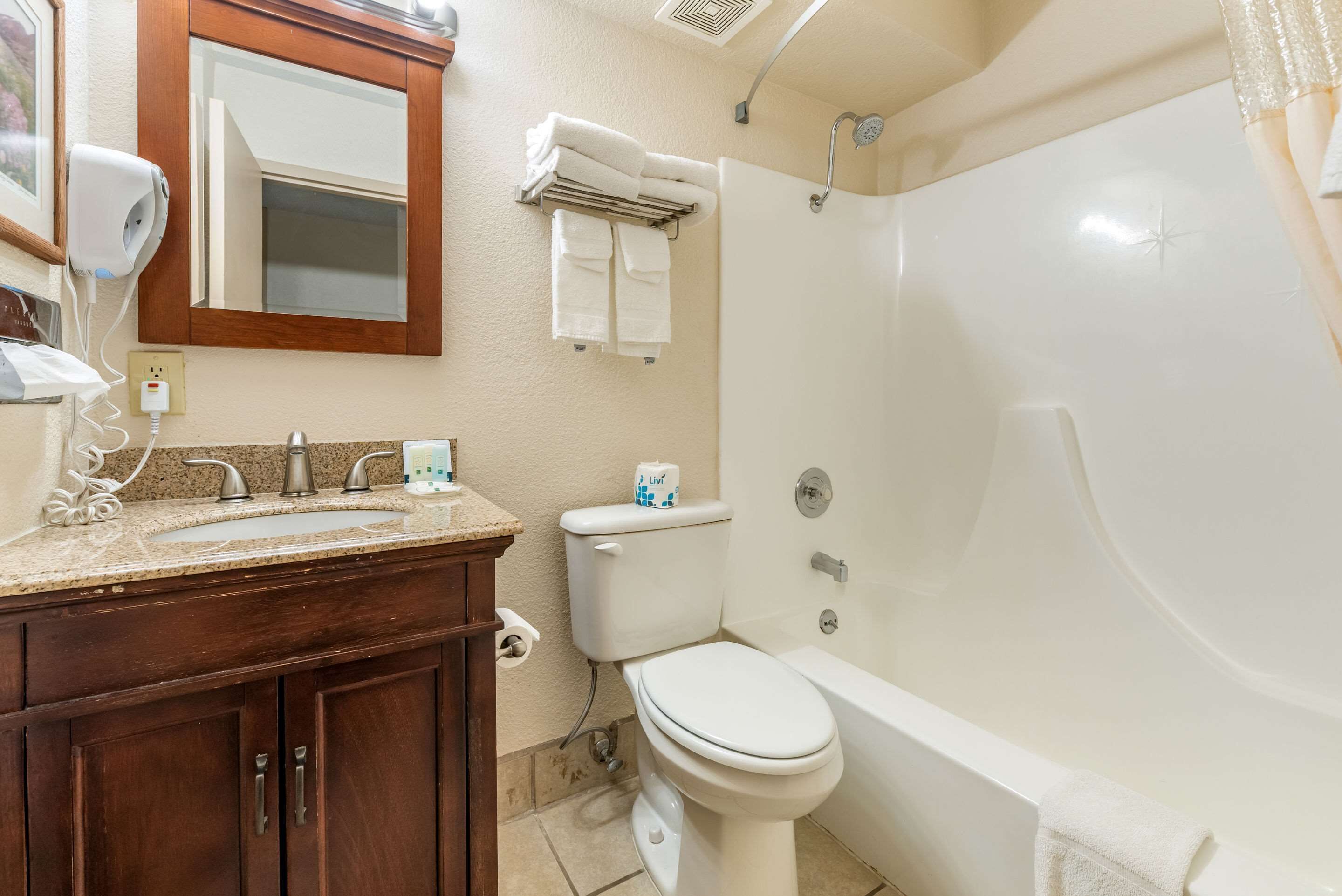 A bathroom with a sink, toilet, and bathtub.