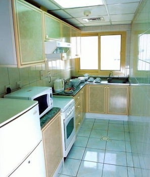 Fridge, microwave, coffee/tea maker, cookware/dishes/utensils