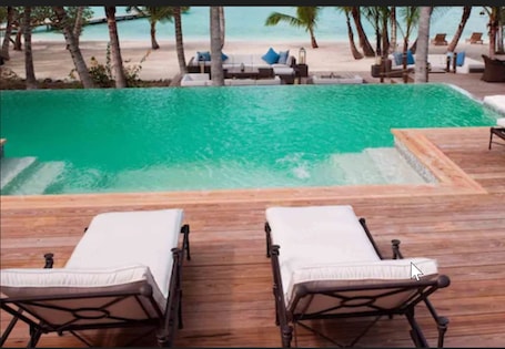 Indoor pool, outdoor pool, pool umbrellas, sun loungers. Tiamo Resort