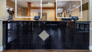 A hotel reception desk with two card readers, a statue of an eagle, and a welcome sign. - Comfort Inn & Suites Statesboro - University Area (Statesboro)