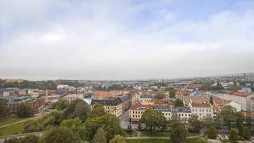 A cityscape with a mix of historic and modern buildings, a prominent church spire, and a clear view of the surrounding urban area.