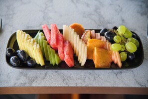 Una bandeja de frutas sobre una encimera de mármol.