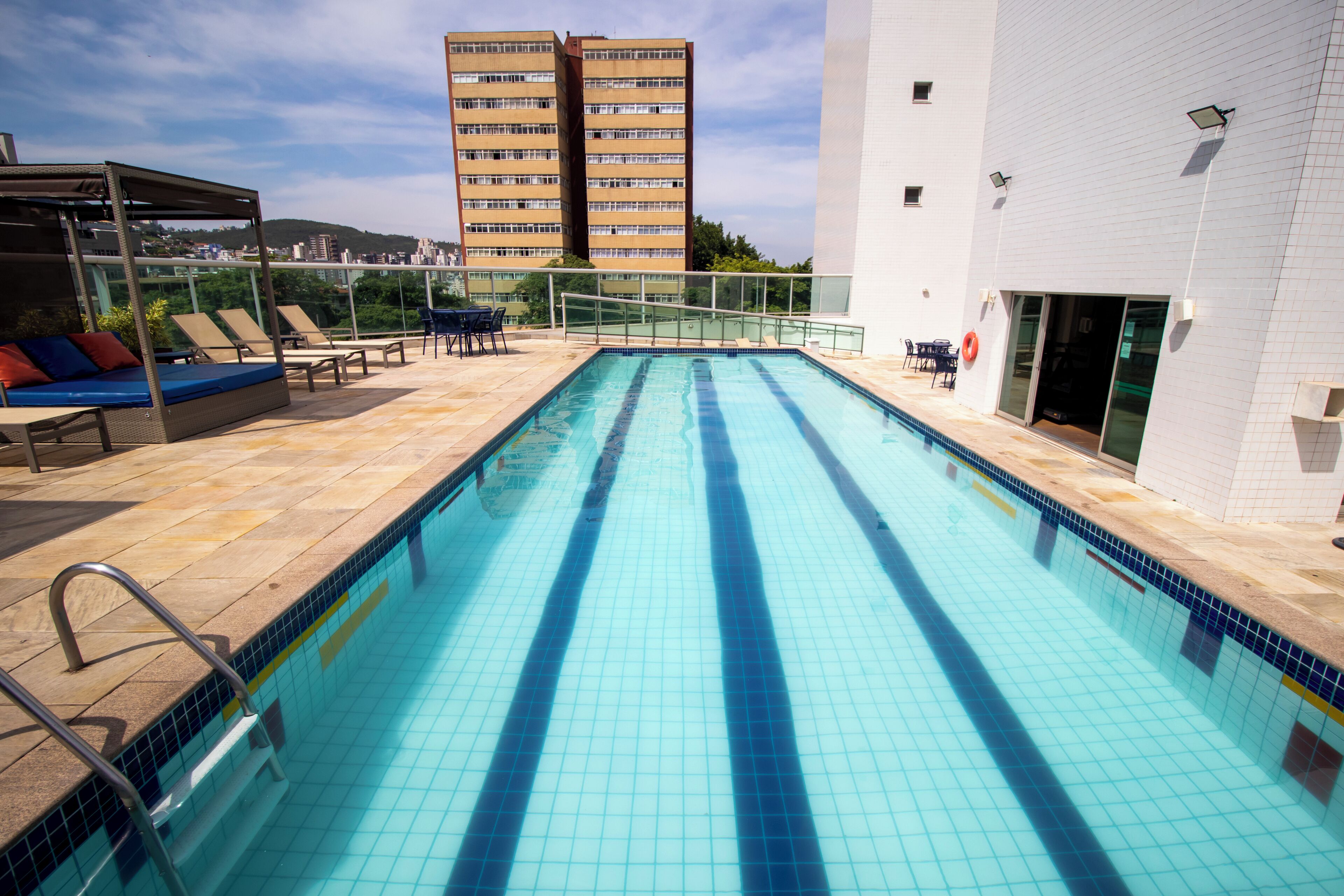 outdoor pool, open 6:00 am to 10:00 pm, pool umbrellas, pool loungers