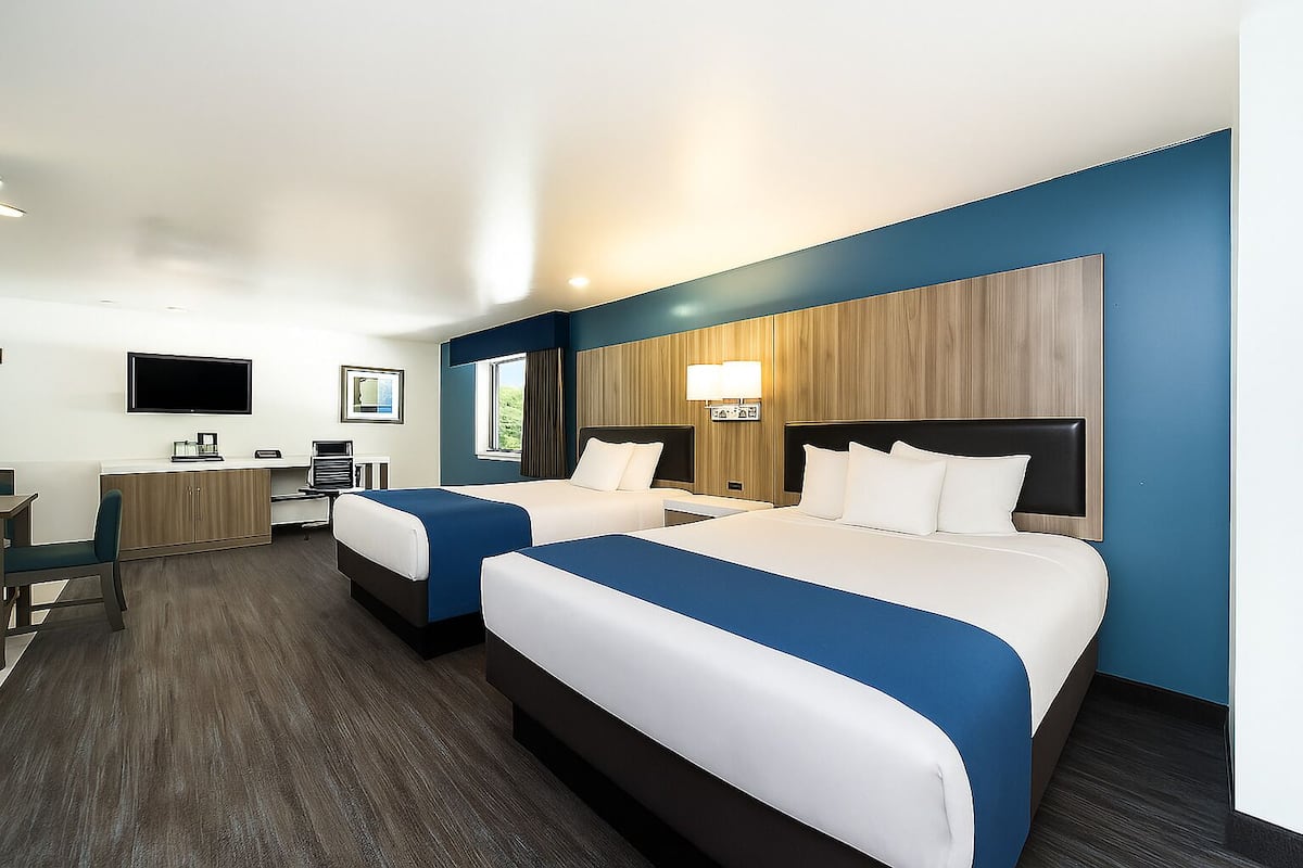 Deluxe Two Queen Studio Plus | Blackout drapes, iron/ironing board, WiFi, bed sheets