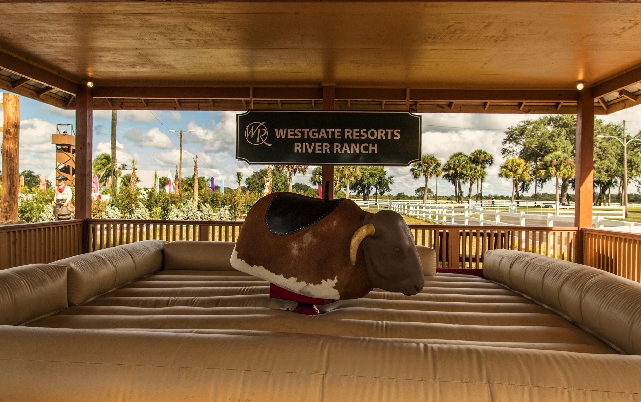 A Westgate Resort River Ranch sign with a bull statue on a bench.