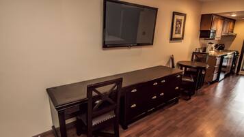 A modern kitchen with a built-in oven, microwave, and coffee maker.
