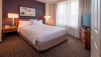Premium bedding, desk, laptop workspace, blackout drapes