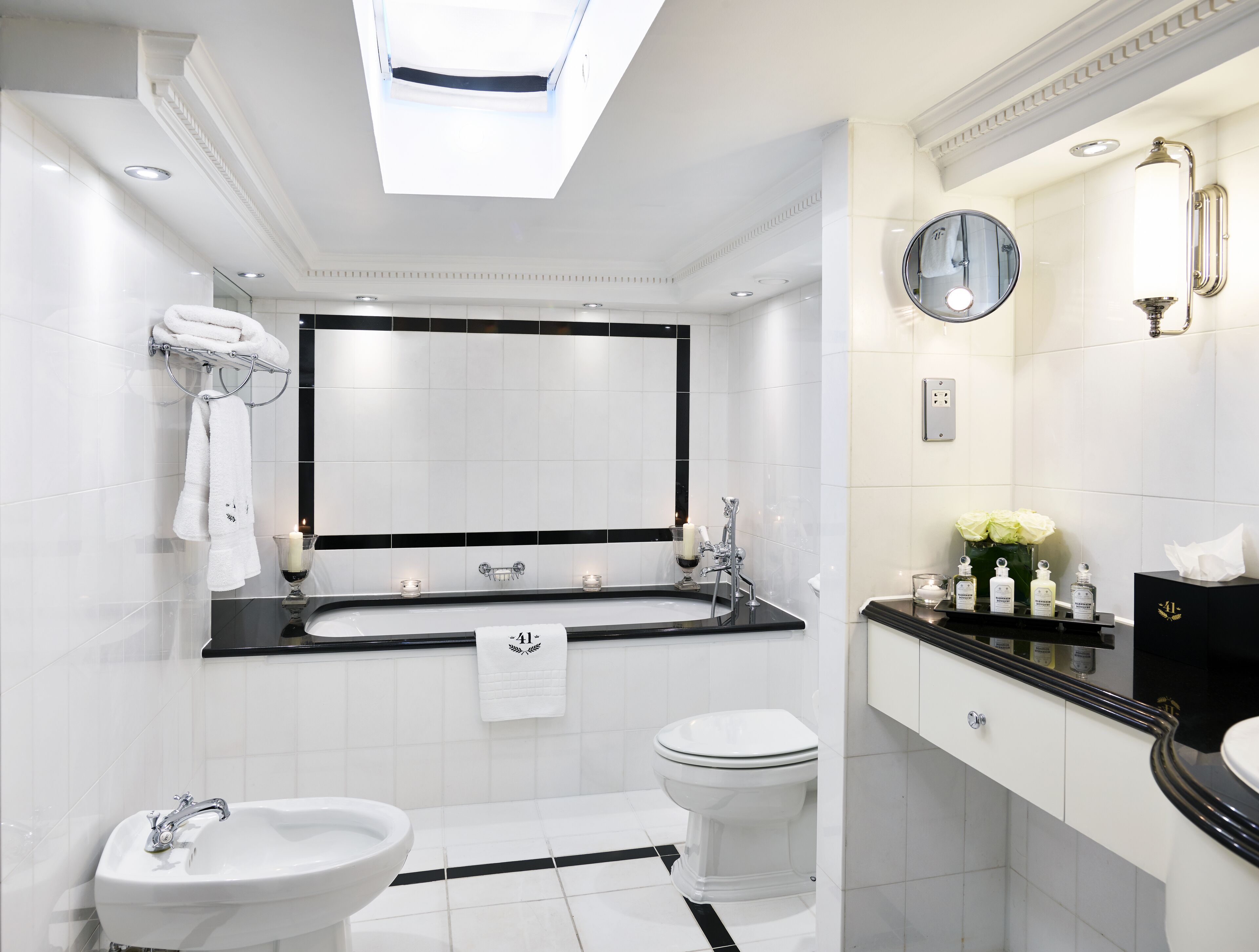 junior suite (split level) | bathroom | combined shower/bathtub, designer toiletries, hair dryer, bathrobes