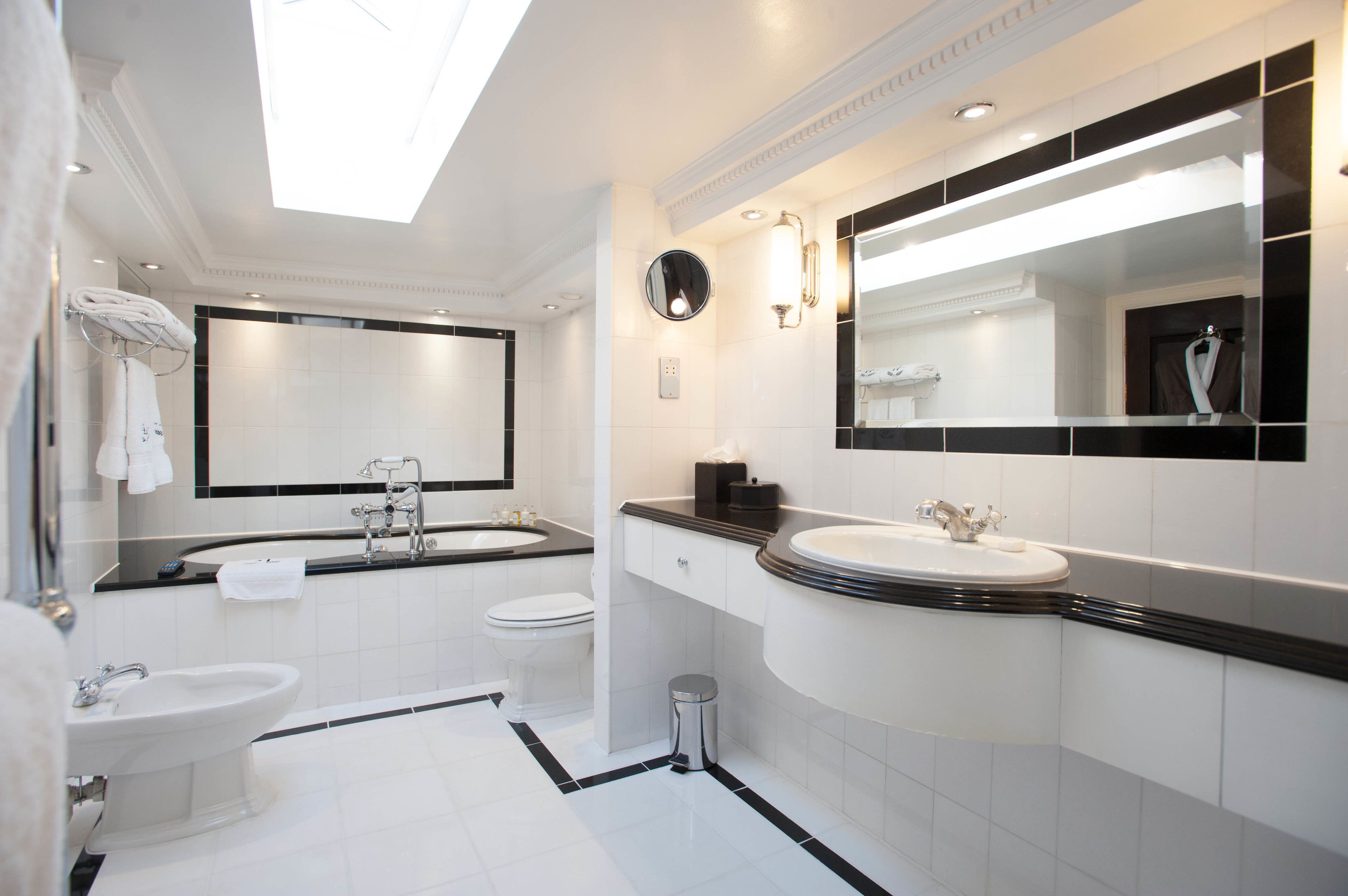 junior suite (split level) | bathroom | combined shower/bathtub, designer toiletries, hair dryer, bathrobes