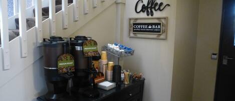 Una estación de café con máquinas de espresso y un letrero que indica barra de café.