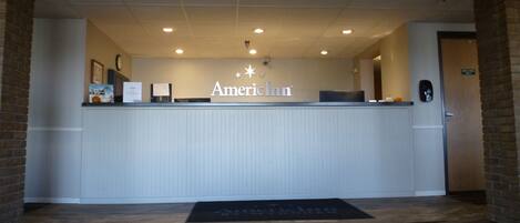 A reception area with a sign reading "American Inn".