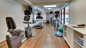 A gym with cardio machines, weightlifting equipment, and exercise balls. - Holiday Inn Express Hotel & Suites Bad Axe by IHG (Bad Axe)