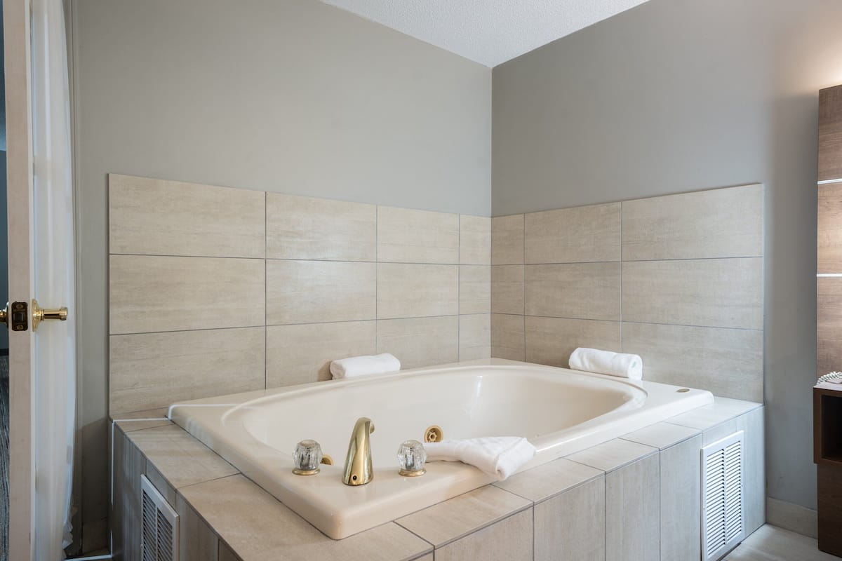 suite, 1 bedroom, jetted tub | in-room safe, desk, iron/ironing board, free rollaway beds