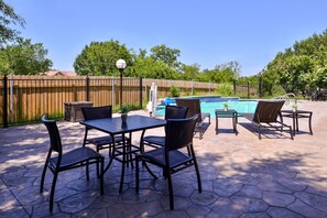 A patio with a pool table, chairs, and a pool. - Holiday Inn Express Hotel & Suites Elgin by IHG (Elgin)