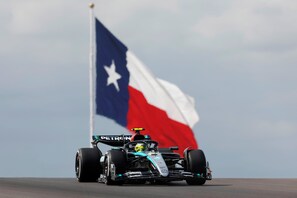A race car on a track with a flag in the background. - Holiday Inn Express Hotel & Suites Elgin by IHG (Elgin)